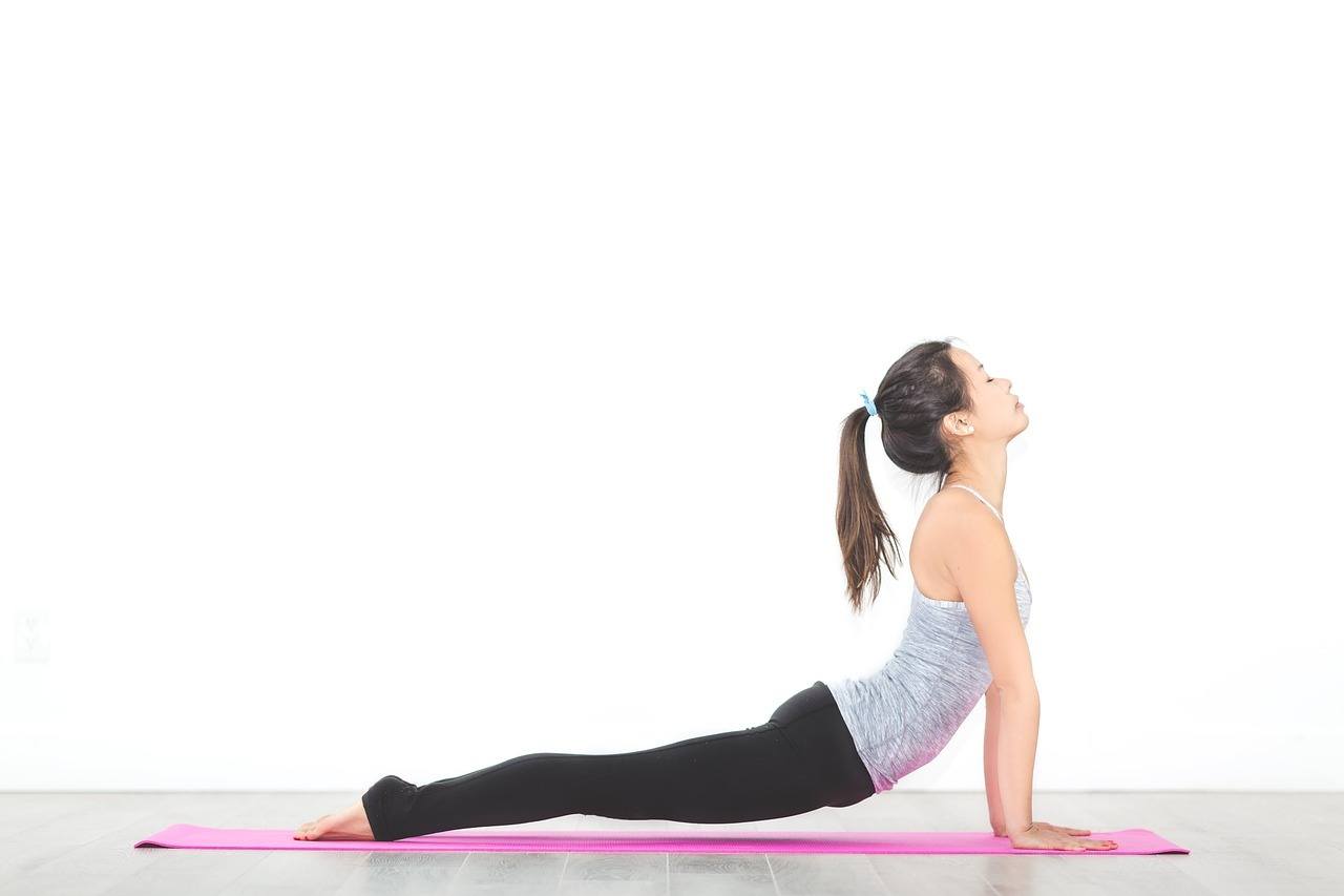 women doing yoga pose cobra stretch