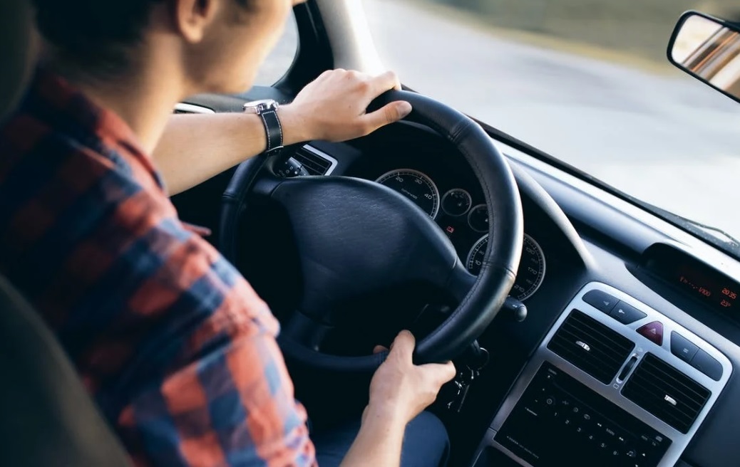 man driving car